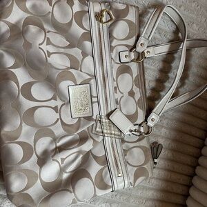 Tan colored coach bag in used condition